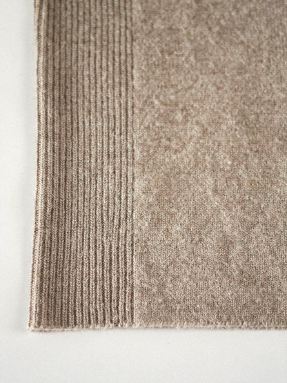 Close-up of the fine-gauge brushed merino knit and ribbed cuff of the Harlbury V-neck jumper
