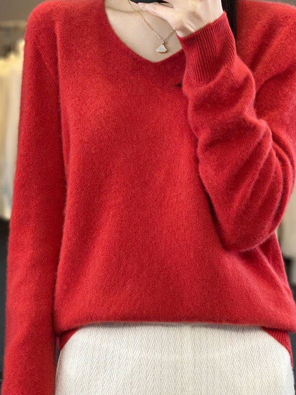 Harlbury merino V-neck jumper in Poppy Red worn with cream trousers