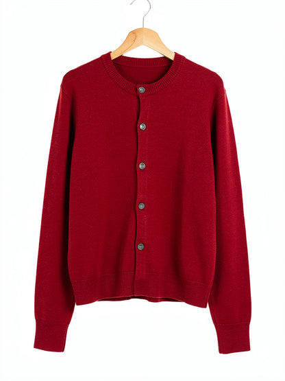 Burgundy merino wool cardigan in Cranberry, front view on a wooden hanger