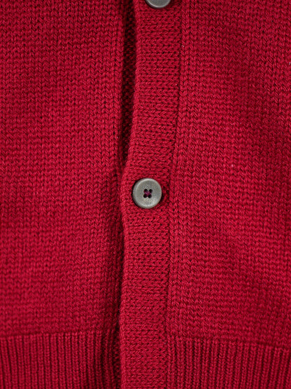 Close up of the fine merino knit and the matte grey four hole buttons