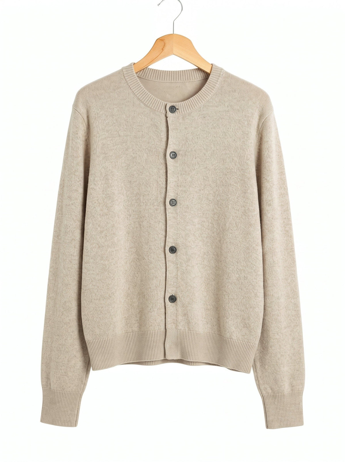 Merino wool cardigan in Limestone, a pale warm greige, front view on a wooden hanger