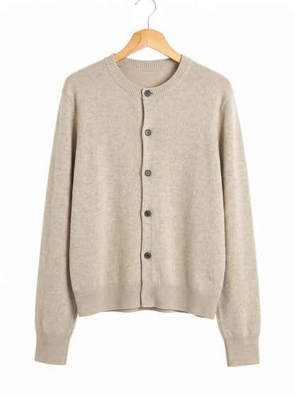 Merino wool cardigan in Limestone, a pale warm greige, front view on a wooden hanger