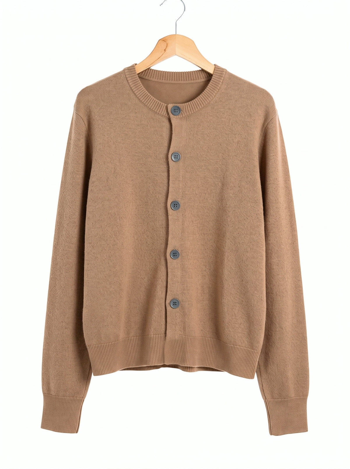 Merino wool cardigan in Saddle, a quiet mid tan, front view on a wooden hanger