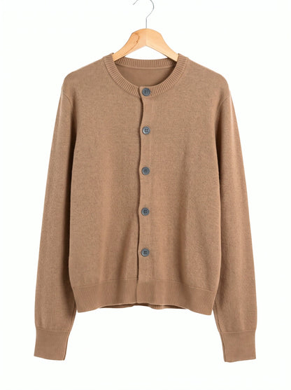 Merino wool cardigan in Saddle, a quiet mid tan, front view on a wooden hanger