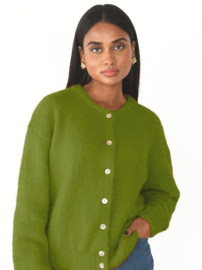 Moss green button-through cardigan worn by a model, studio photo