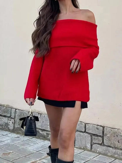 Off the shoulder jumper in Scarlet worn with a black mini skirt and boots