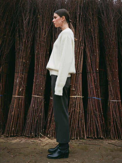 Oversized crew neck jumper in Thistledown worn beside a willow store