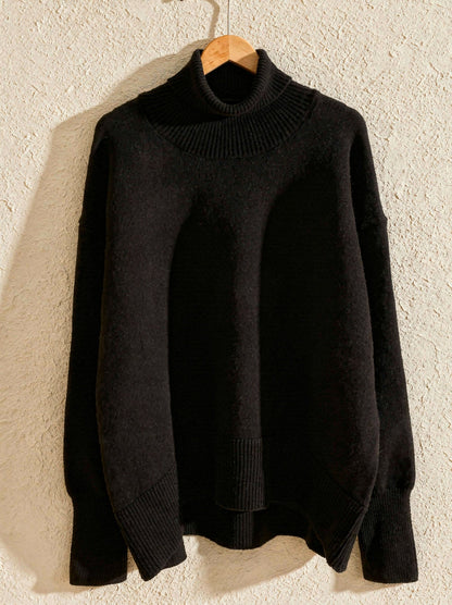 Black oversized funnel neck jumper with ribbed collar, split hem and dipped back, on a hanger