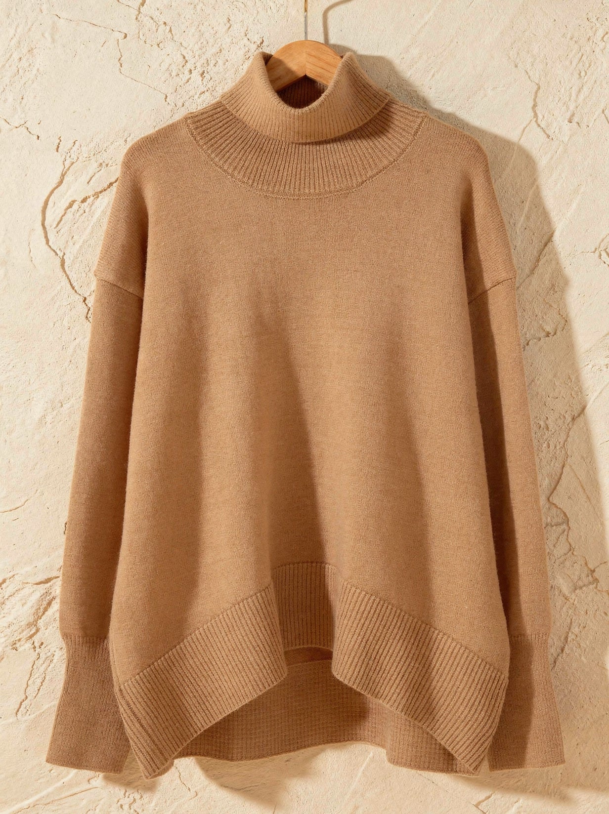 Camel oversized funnel neck jumper with ribbed collar, split hem and dipped back, on a hanger