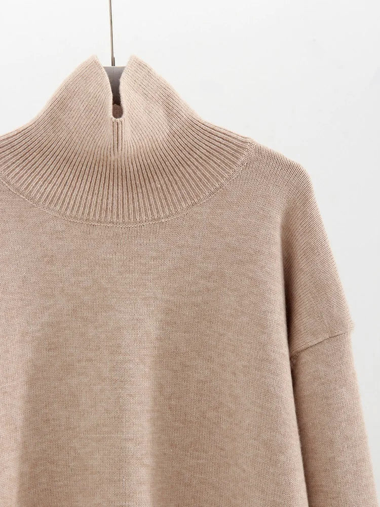 Close-up of the wide ribbed funnel neck and smooth jersey knit in oatmeal
