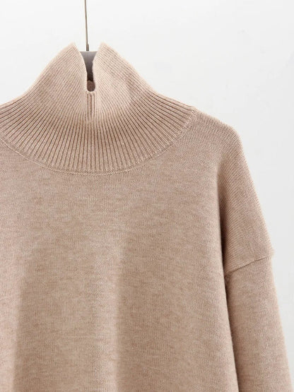 Close-up of the wide ribbed funnel neck and smooth jersey knit in oatmeal