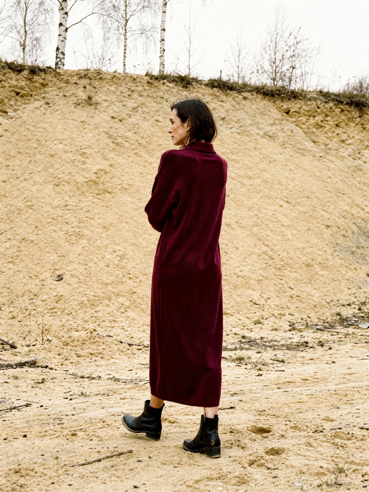 Oversized jumper dress in Claret seen from behind, dropped shoulders and mid calf hem