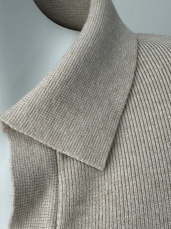 Open shirt collar of the knitted jumper dress in Oat Marl, folded flat over the fine rib