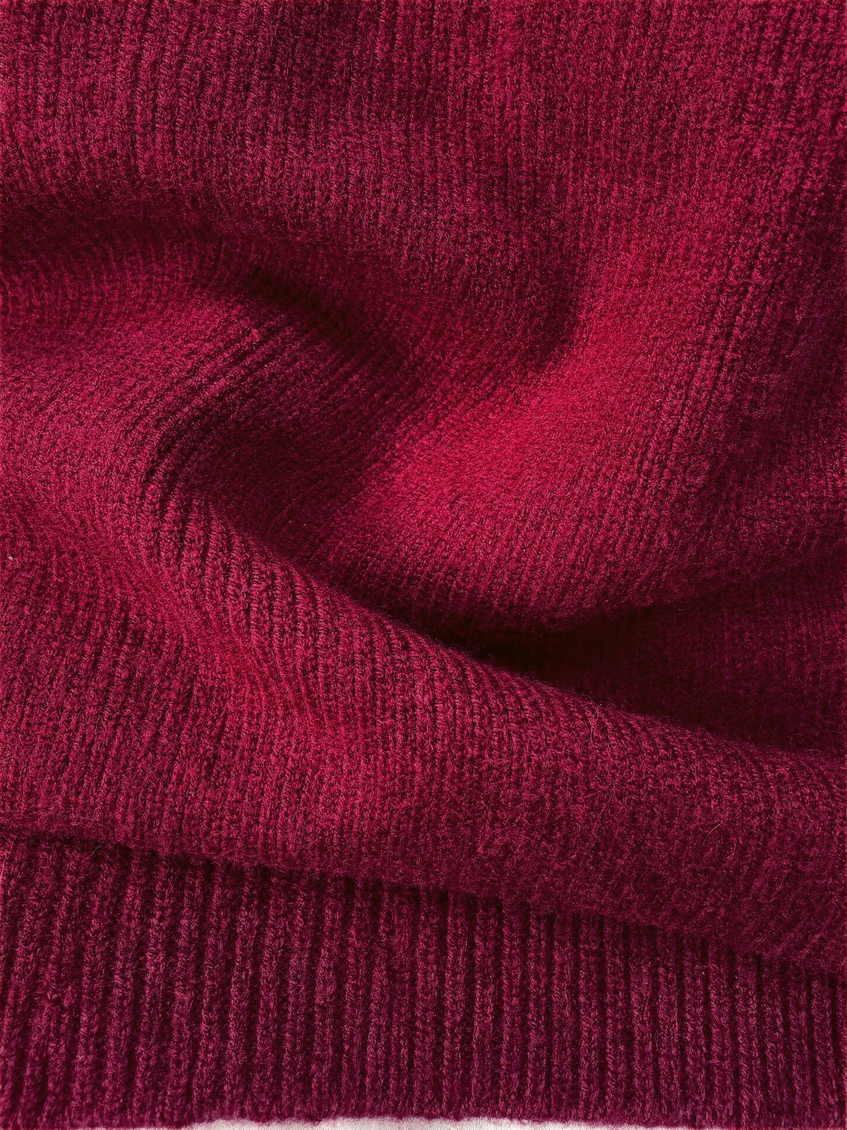 Close up of the fine rib knit and ribbed hem band of the Claret jumper dress