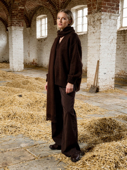 Womens oversized jumper in Oakbark deep chocolate brown with its matching scarf, worn in an English maltings