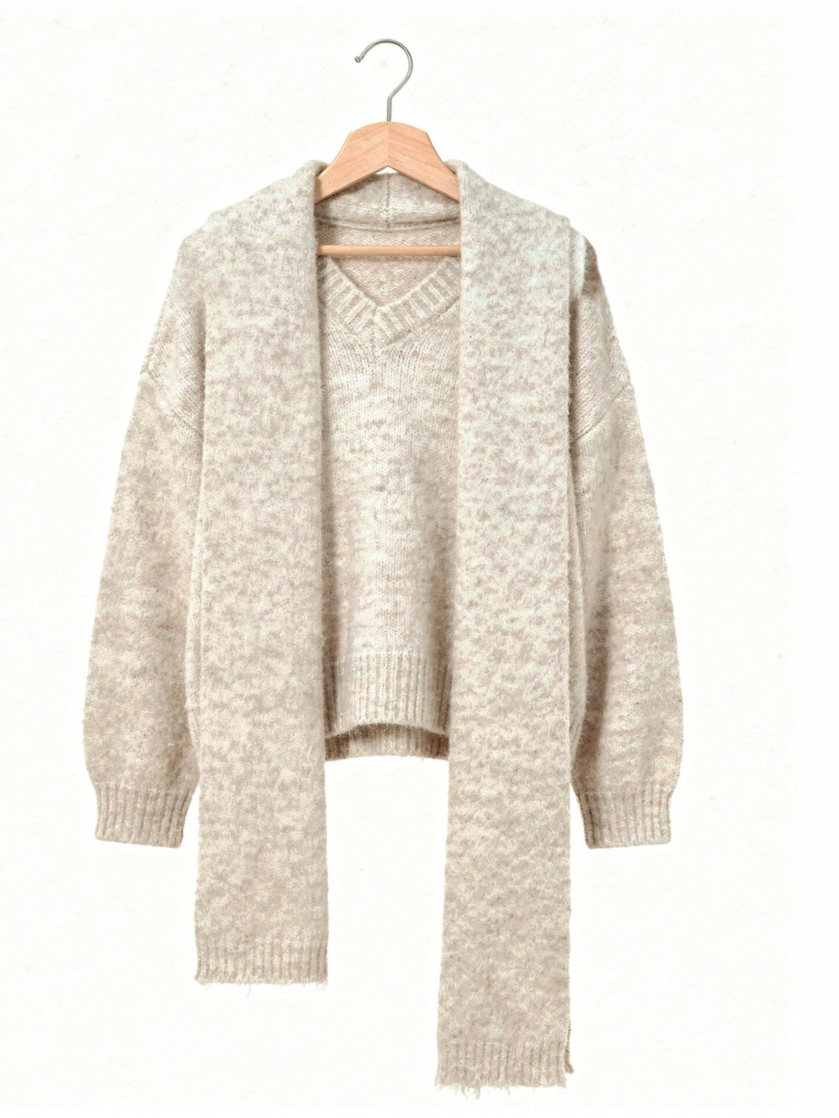 Oversized V neck jumper and matching scarf in Rushlight cream, shown on a wooden hanger