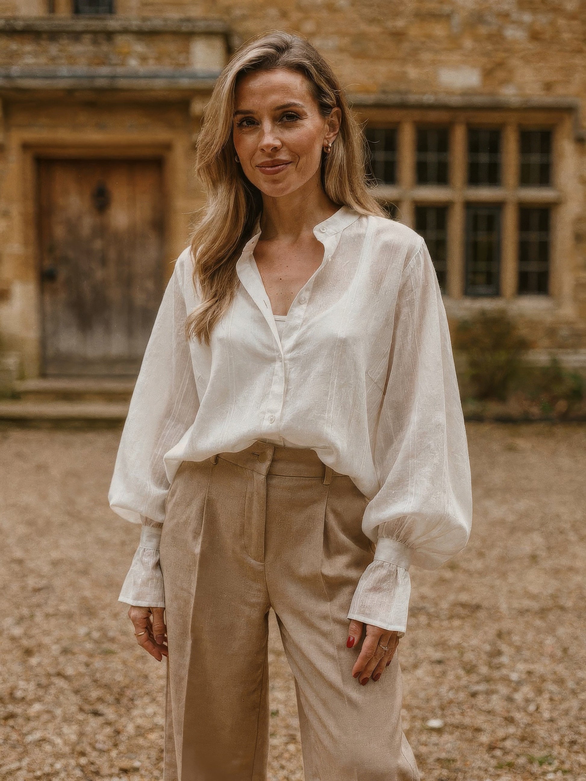 Womens oversized white tunic shirt with bishop sleeves, three-quarter front view