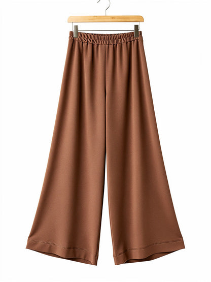 Cinnamon brown palazzo trousers on a hanger, pull on elasticated waist and wide leg