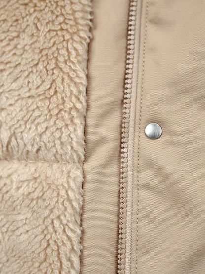Close up of the deep borg fleece lining against the smooth unquilted shell of the parka coat