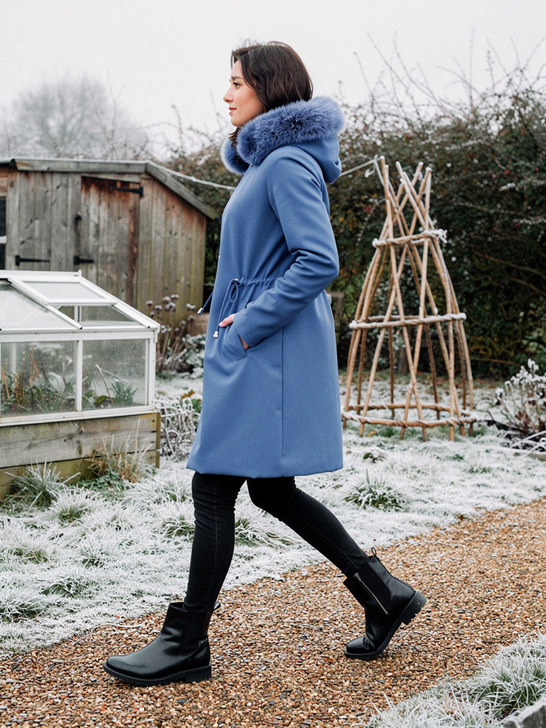 Parka coat in Delft Blue seen from the side, the drawcord waist drawing the shape in