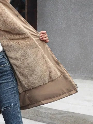 Parka coat held open to show the borg fleece lining, the press stud placket and the hem