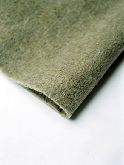 Close up of the double faced brushed wool cloth and its clean cut unlined edge