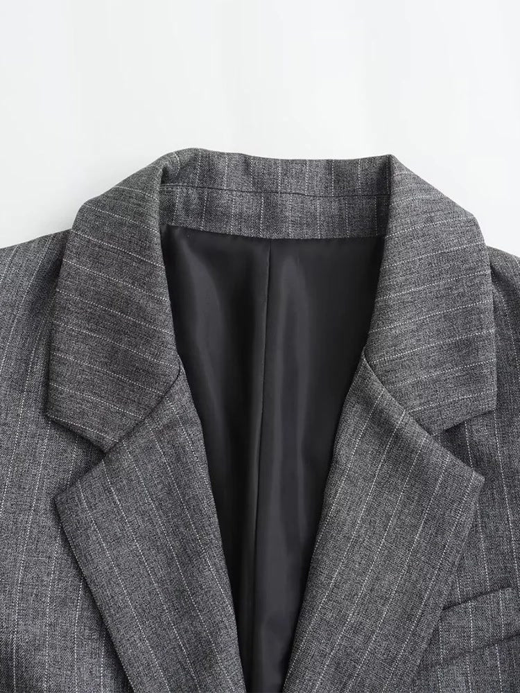 Notch lapel and dark lining of the grey pinstripe blazer