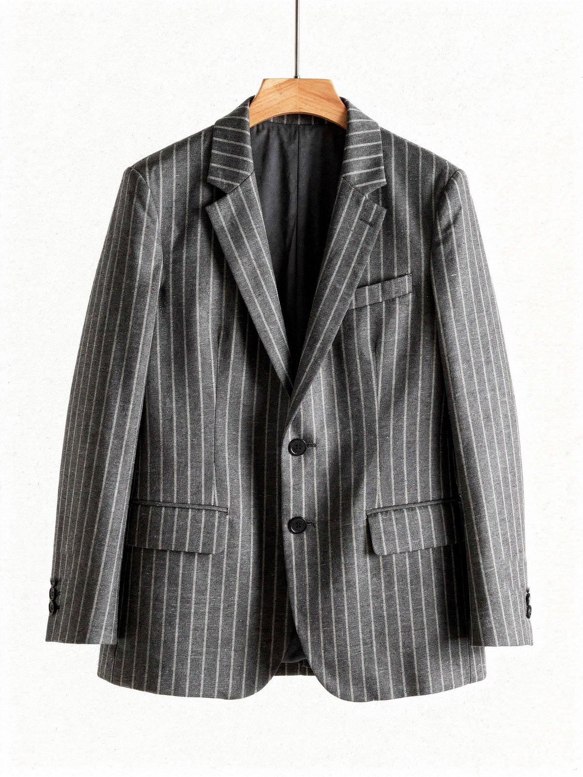 Grey pinstripe blazer on a wooden hanger, front view