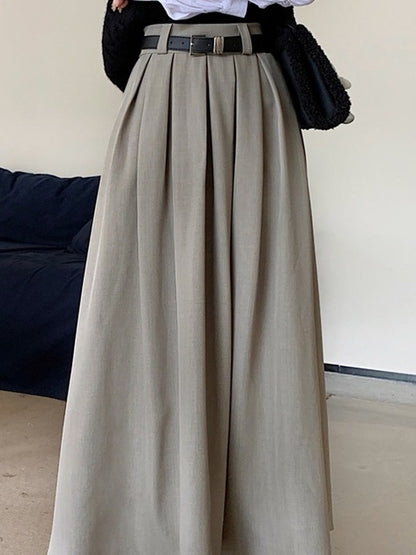 Belt loops and box pleats on the greige midi skirt, supplier photograph