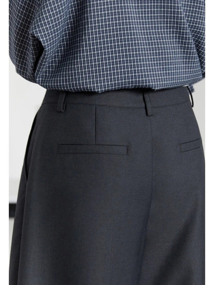 Back waistband and welt pockets of slate grey pleated trousers