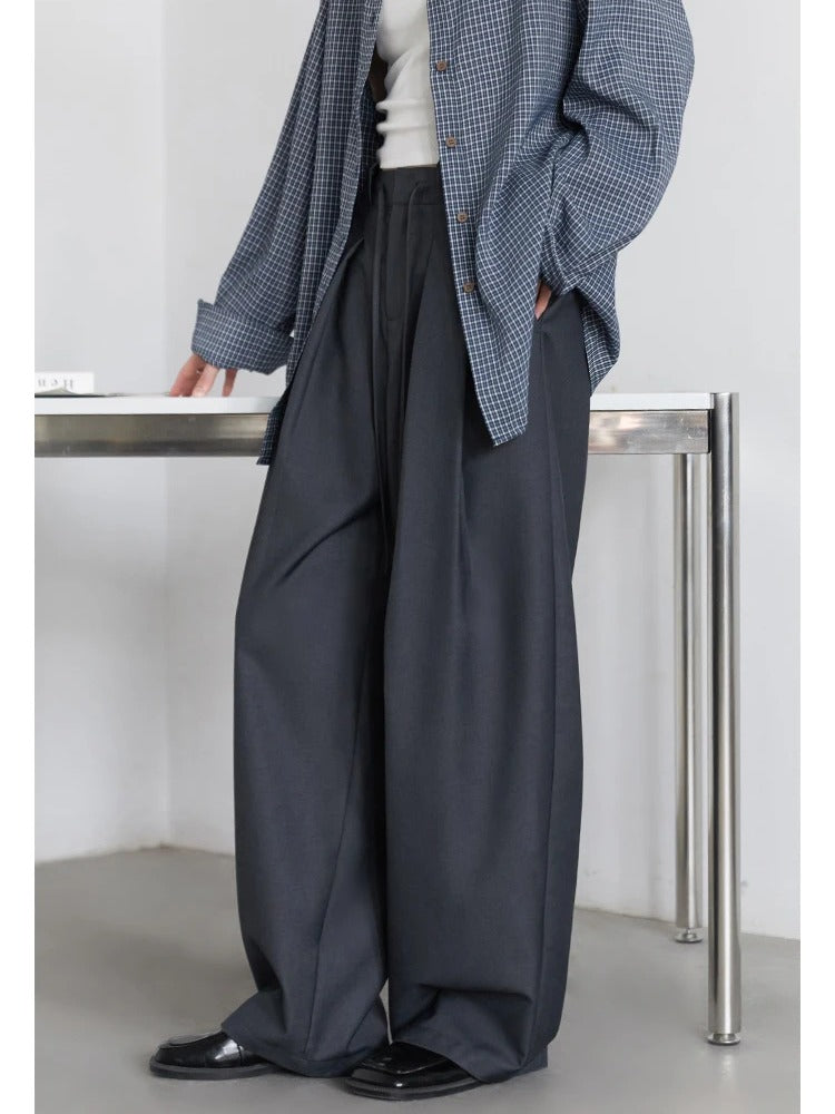 Slate grey pleated trousers worn, three quarter view