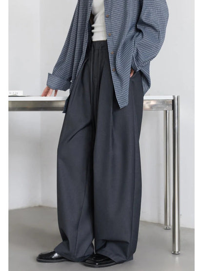 Slate grey pleated trousers worn, three quarter view