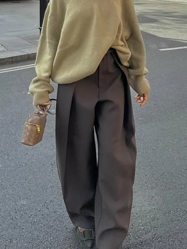 Pleated wide-leg trousers in peat brown seen from behind