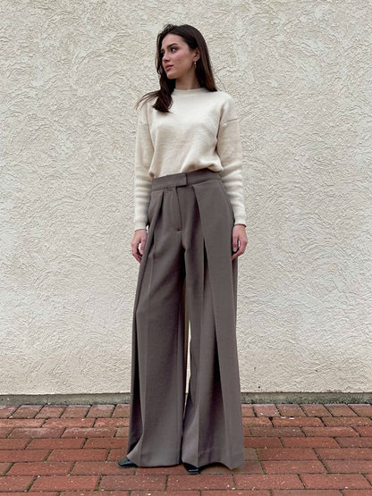 Woman wearing pleated wide-leg trousers in peat brown, full length