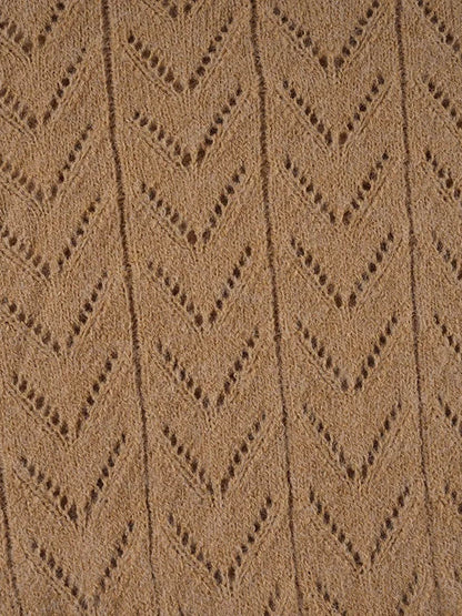 Close-up of the open chevron pointelle knit texture of the camel jumper