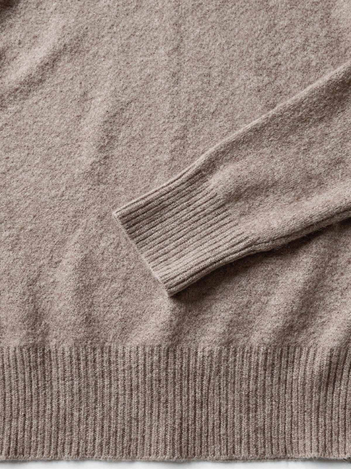 Close-up of the deep ribbed cuff and the soft brushed halo of the polo neck jumper
