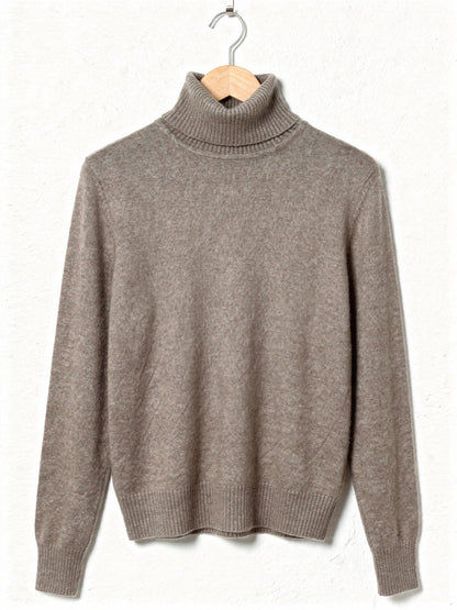 Teasel polo neck jumper on a hanger, showing the tall folded roll neck, the deep ribbed cuffs and the smooth brushed knit