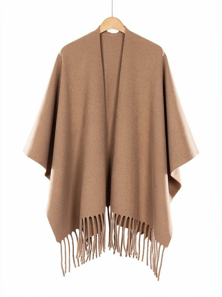 Open-front poncho cape in Hazel on a wooden hanger, showing the split front and the fringed hem