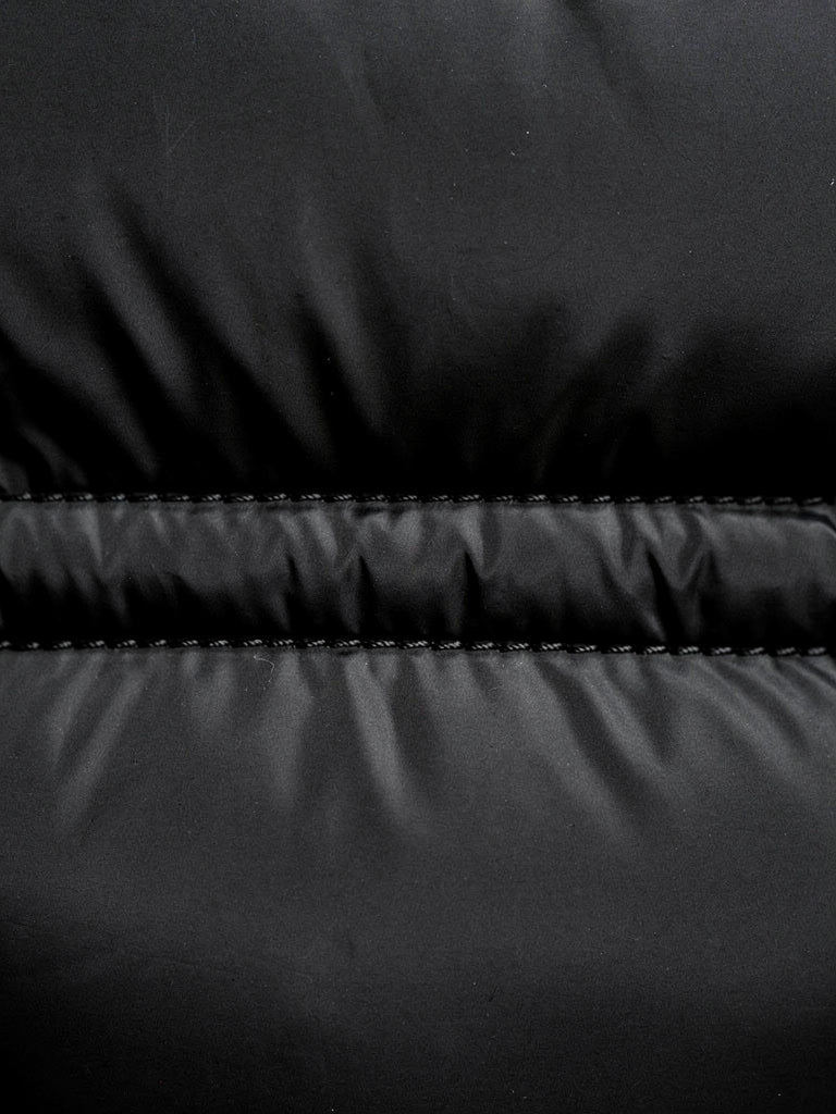 Close up of the wide quilted panels on the black puffer jacket