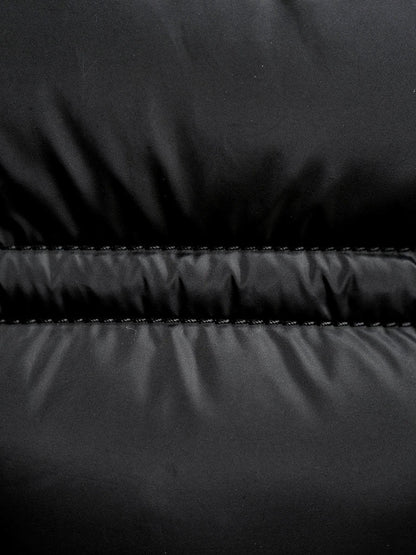 Close up of the wide quilted panels on the black puffer jacket
