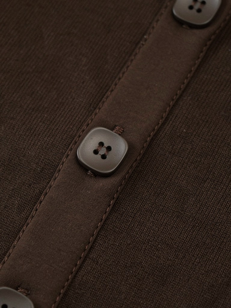 Close-up of the fine cotton rib and matt square buttons of the ribbed maxi dress