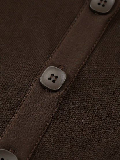 Close-up of the fine cotton rib and matt square buttons of the ribbed maxi dress