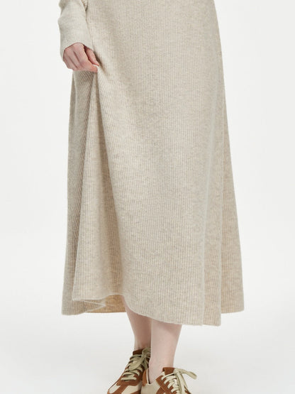 Supplier photograph of the ribbed midi skirt in porridge, worn from the front, showing the A-line flare and the level hem