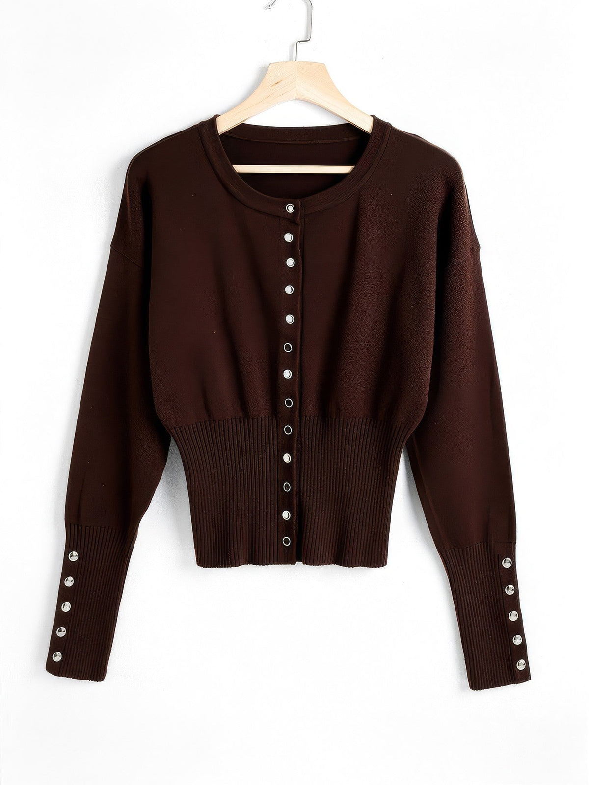 Cropped round-neck cardigan in Bitter Chocolate on a hanger, thirteen silver press studs