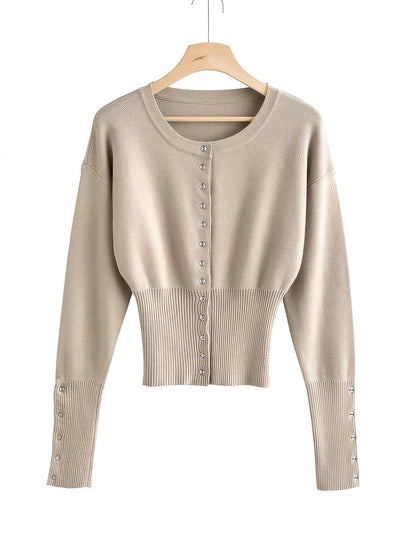 Cropped round-neck cardigan in Wheat on a hanger, ribbed waist panel and silver press studs