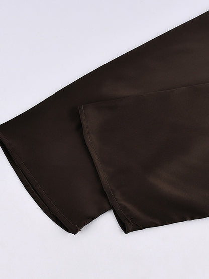 Close up of the wide flared sleeve hem on the satin blouse