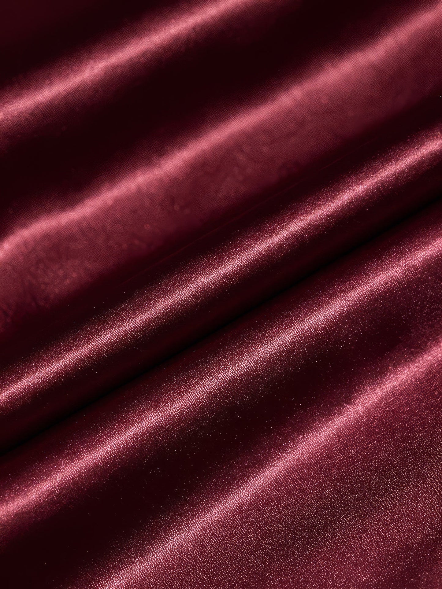 Close-up of the satin weave of the midi dress, showing the sheen along each fold