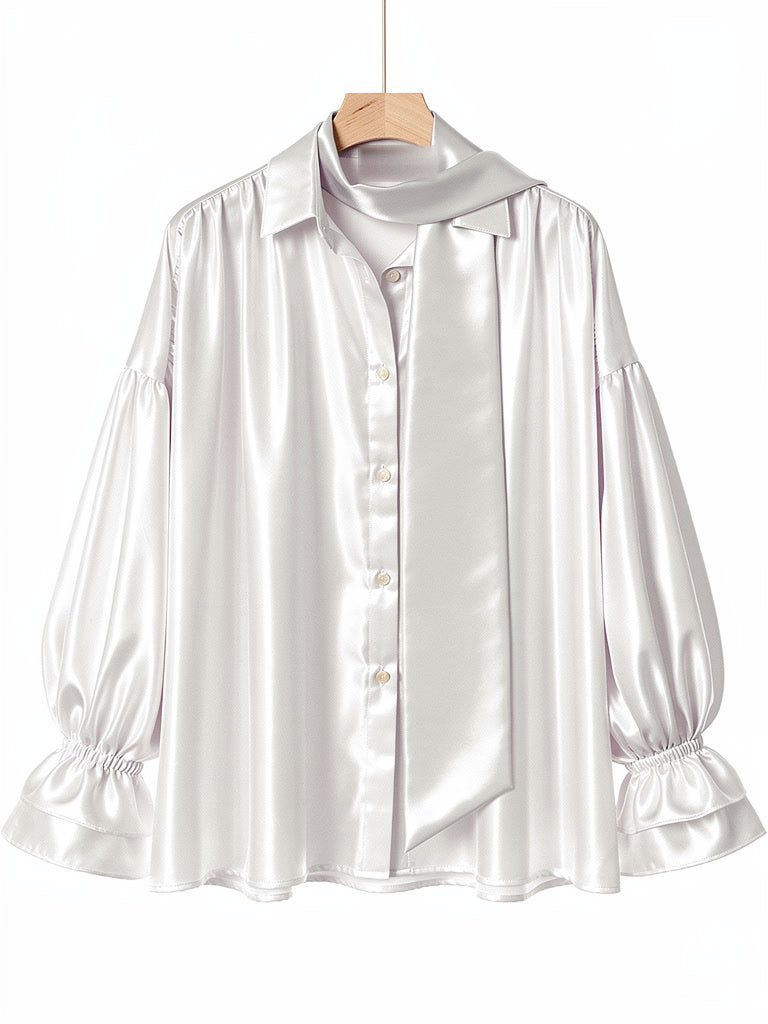 Ivory satin puff sleeve blouse on a hanger, front view with tie scarf