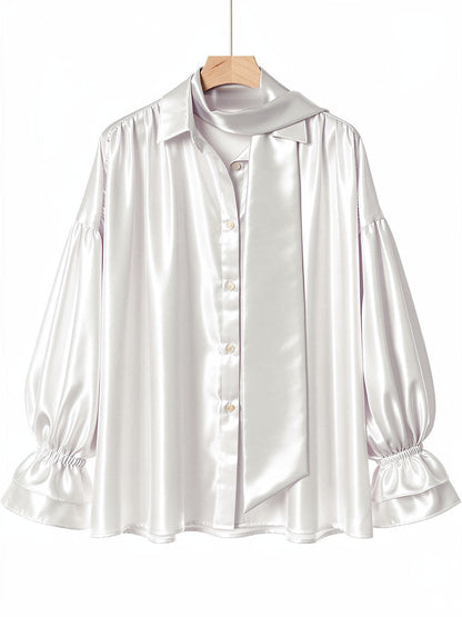 Ivory satin puff sleeve blouse on a hanger, front view with tie scarf