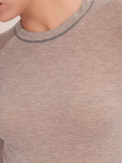 Close-up of the bead-effect collar trim and woven-in shimmer of the knit